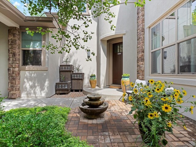 9266 E 35th Ave, Denver, CO 80238 - doorway to property with stucco siding and a patio