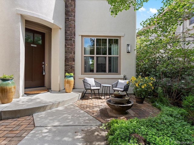 9266 E 35th Ave, Denver, CO 80238 - doorway to property with stucco siding, a patio, and stone siding