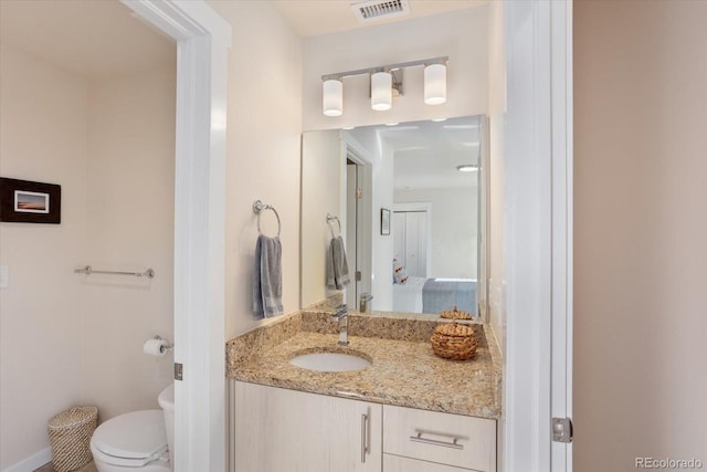 bathroom with vanity and toilet