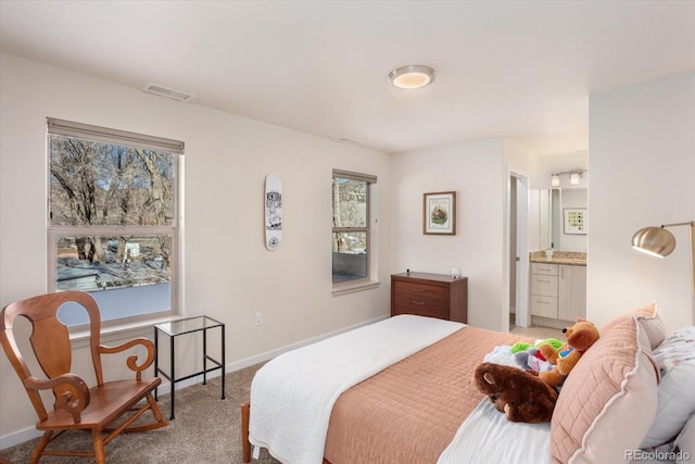 carpeted bedroom featuring connected bathroom