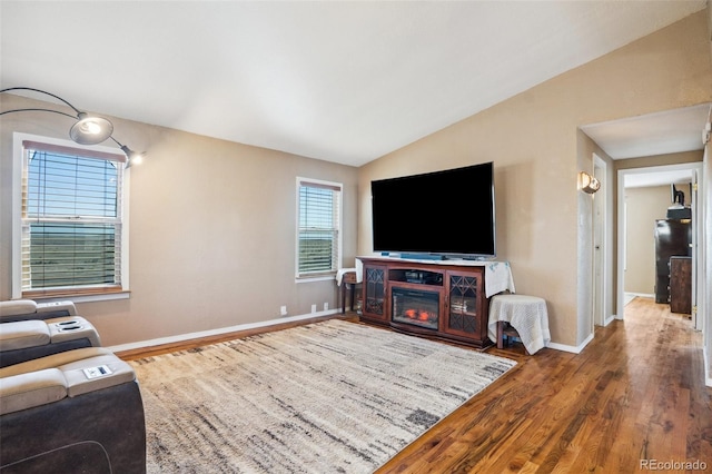 6670 Indian Village Hts, Fountain, CO 80817 - living area with wood finished floors, baseboards, and vaulted ceiling