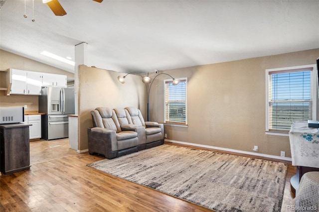 6670 Indian Village Hts, Fountain, CO 80817 - living room with light wood-style floors, ceiling fan, baseboards, and vaulted ceiling