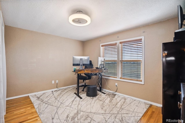 6670 Indian Village Hts, Fountain, CO 80817 - office space with wood finished floors, baseboards, a textured ceiling, and a textured wall
