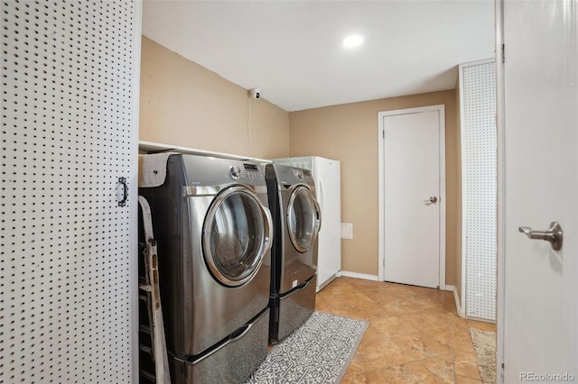 6670 Indian Village Hts, Fountain, CO 80817 - laundry area with washing machine and clothes dryer and baseboards