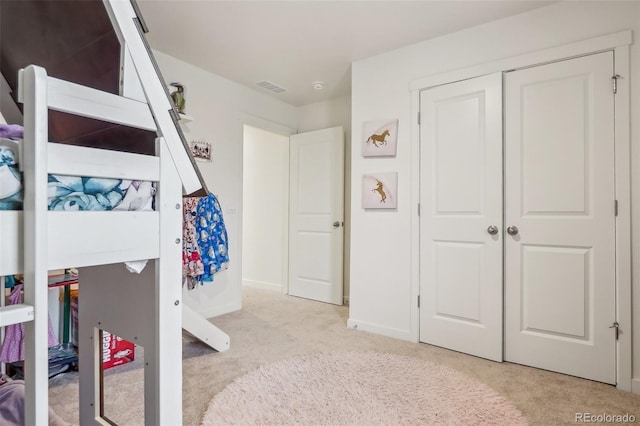 715 N Amory St, Watkins, CO 80137 - bedroom with light carpet, a closet, and baseboards
