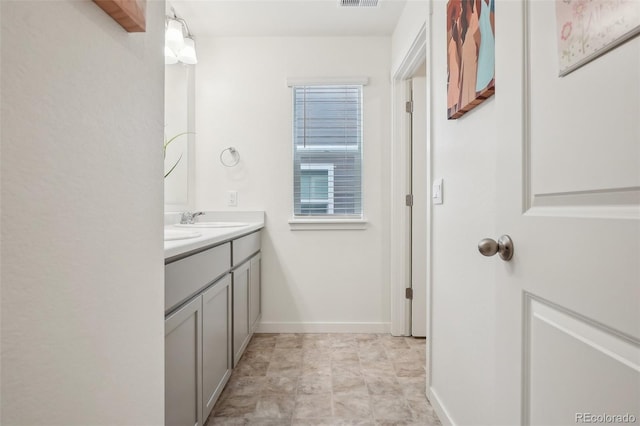 715 N Amory St, Watkins, CO 80137 - bathroom featuring double vanity and baseboards