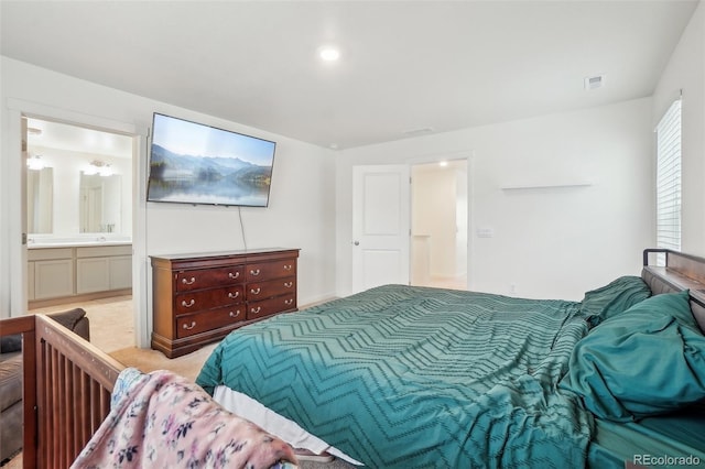 715 N Amory St, Watkins, CO 80137 - bedroom featuring ensuite bath, a sink, and light colored carpet