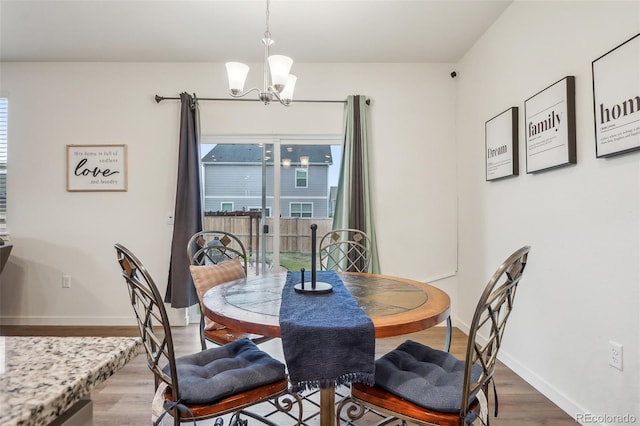 715 N Amory St, Watkins, CO 80137 - dining room featuring a chandelier, wood finished floors, and baseboards