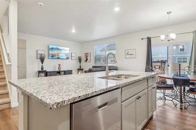 715 N Amory St, Watkins, CO 80137 - kitchen featuring dishwasher, a sink, a chandelier, an island with sink, and light wood finished floors