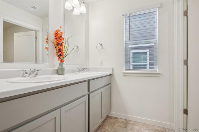 715 N Amory St, Watkins, CO 80137 - bathroom with double vanity and baseboards