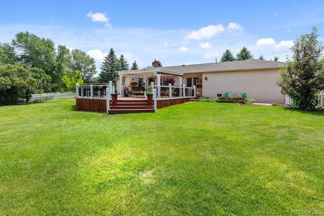 back of house featuring a yard and a deck