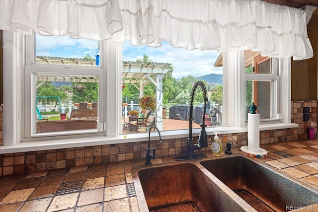 interior details featuring a mountain view and sink