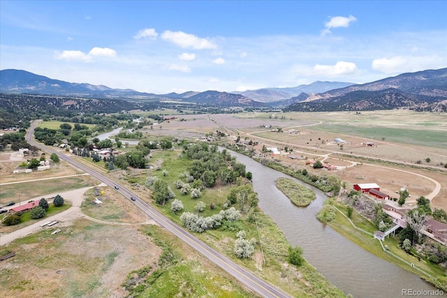 drone / aerial view with a water and mountain view