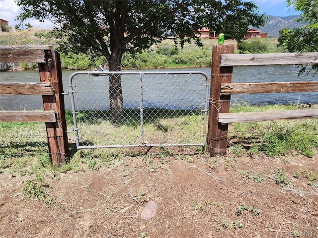 view of gate with a water view