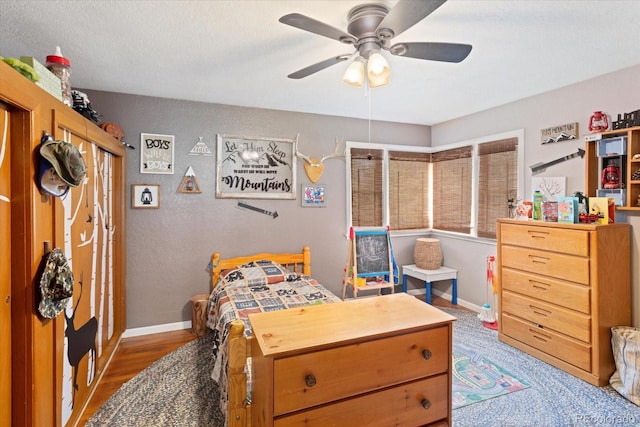 bedroom featuring ceiling fan and wood-type flooring