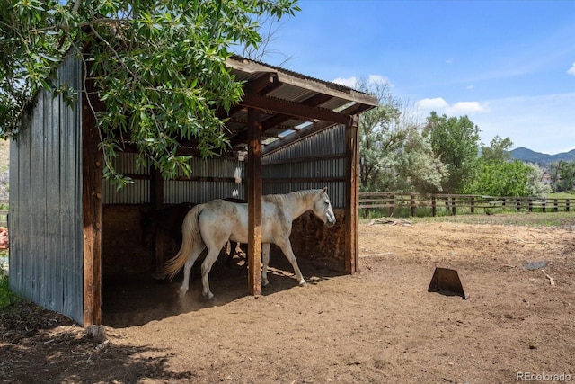 view of horse barn featuring a mountain view