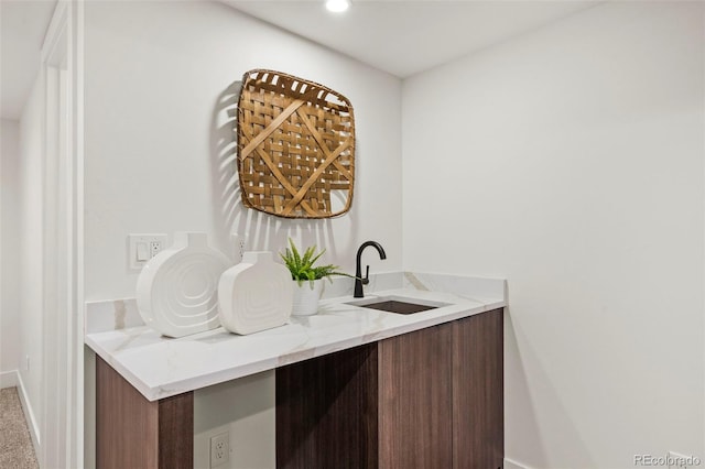 bar with sink and light stone counters