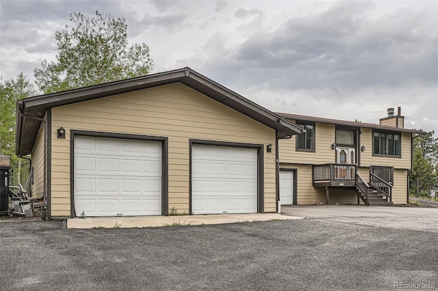 30839 Manitoba Dr, Evergreen, CO 80439 - view of front of property featuring a chimney and a detached garage
