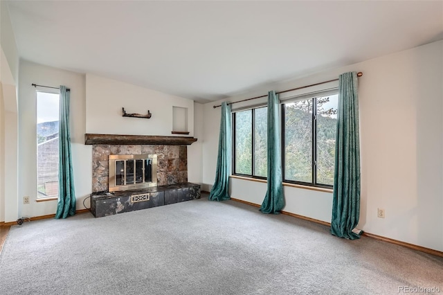 30839 Manitoba Dr, Evergreen, CO 80439 - unfurnished living room featuring carpet floors, healthy amount of natural light, and a fireplace
