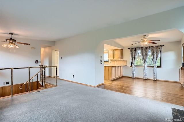 30839 Manitoba Dr, Evergreen, CO 80439 - unfurnished living room with a ceiling fan, light colored carpet, and light wood-type flooring