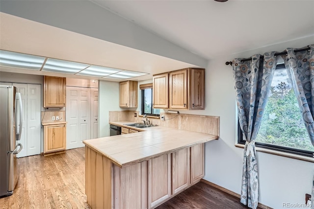 30839 Manitoba Dr, Evergreen, CO 80439 - kitchen featuring freestanding refrigerator, light wood-type flooring, a peninsula, tile counters, and black dishwasher