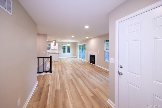 8713 E Roundtree Ave, Greenwood Village, CO 80111 - corridor with an upstairs landing, light wood finished floors, and recessed lighting