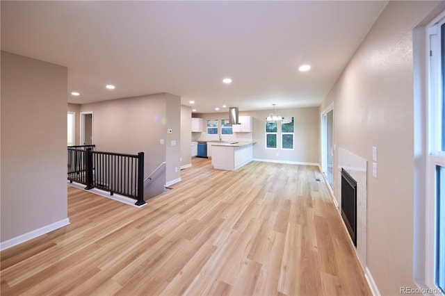 8713 E Roundtree Ave, Greenwood Village, CO 80111 - unfurnished living room with a chandelier, light wood finished floors, recessed lighting, and a fireplace