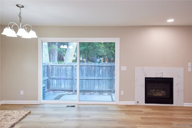 8713 E Roundtree Ave, Greenwood Village, CO 80111 - unfurnished living room with light wood-style flooring, a chandelier, healthy amount of natural light, and recessed lighting