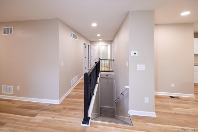 8713 E Roundtree Ave, Greenwood Village, CO 80111 - corridor featuring an upstairs landing, light wood-style flooring, and recessed lighting