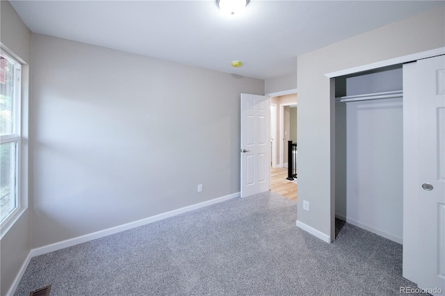 8713 E Roundtree Ave, Greenwood Village, CO 80111 - unfurnished bedroom featuring light carpet and a closet