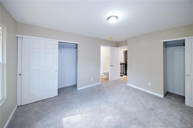 8713 E Roundtree Ave, Greenwood Village, CO 80111 - unfurnished bedroom featuring carpet floors and multiple closets