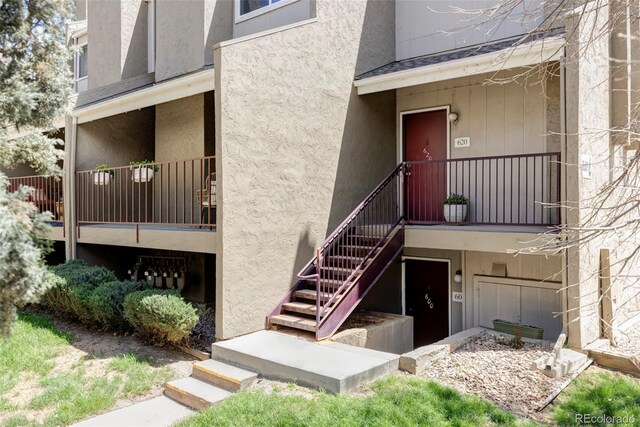 entrance to property featuring stucco siding