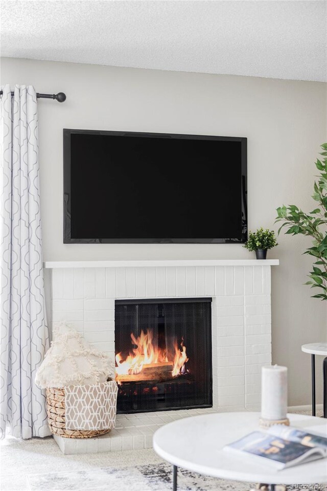 detailed view of a brick fireplace and a textured ceiling