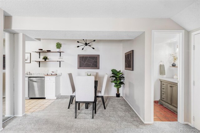 dining space with light colored carpet, light tile patterned floors, lofted ceiling, a textured ceiling, and baseboards