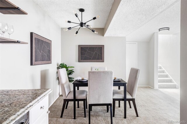 dining area with light carpet, a chandelier, a textured ceiling, and stairway