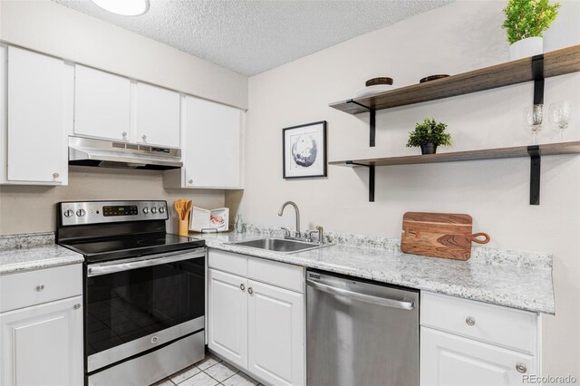 kitchen featuring appliances with stainless steel finishes, under cabinet range hood, a sink, open shelves, and a textured ceiling