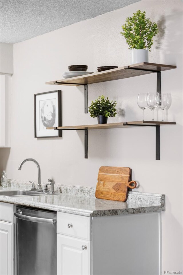 indoor bar featuring dishwasher and a textured ceiling