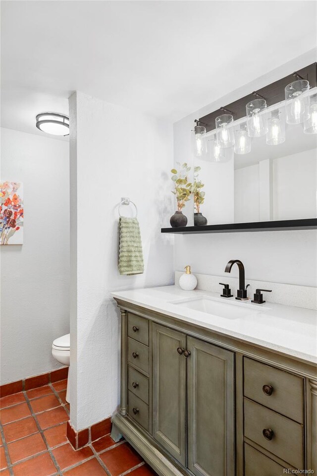bathroom featuring vanity, toilet, and tile patterned flooring