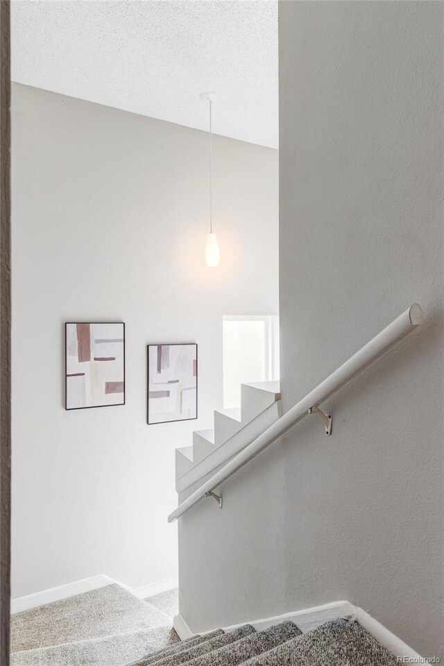 stairs featuring carpet and baseboards