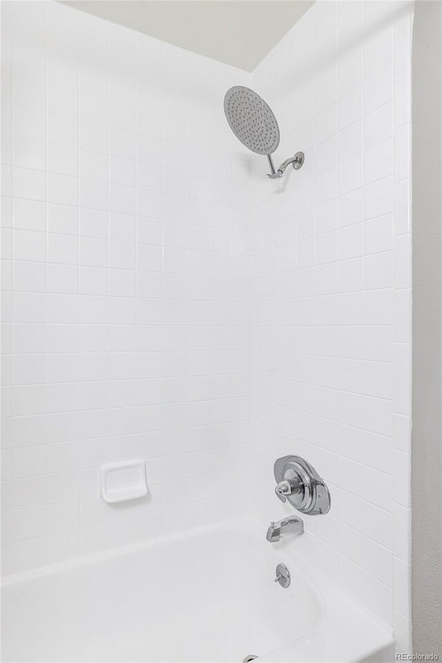 bathroom view of bathtub / shower combination
