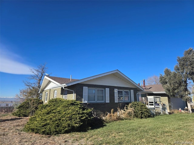 view of side of home with a lawn