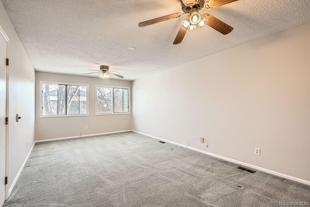 carpeted empty room featuring a textured ceiling and ceiling fan