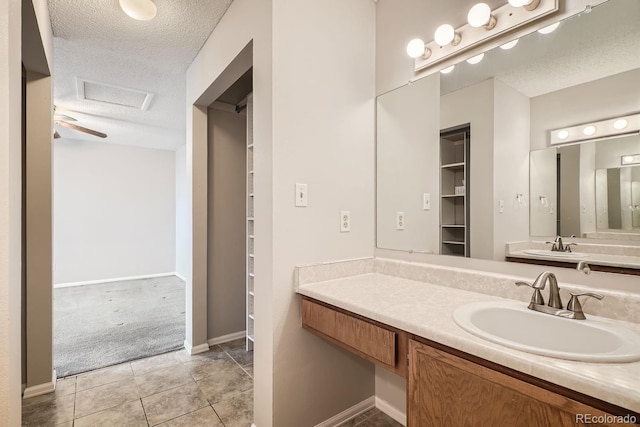 bathroom featuring a textured ceiling, vanity, and tile patterned floors