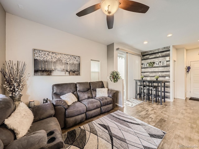 living room featuring ceiling fan and light hardwood / wood-style floors