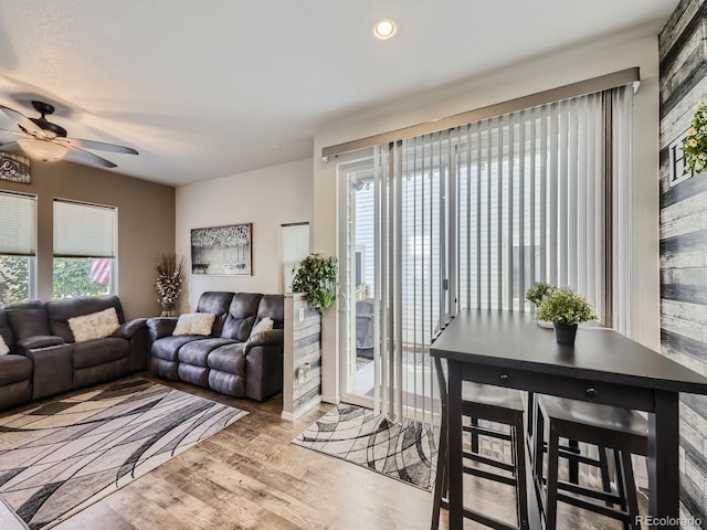 living room with light wood-type flooring and ceiling fan