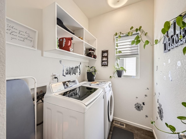 laundry area featuring washer and clothes dryer and wood-type flooring