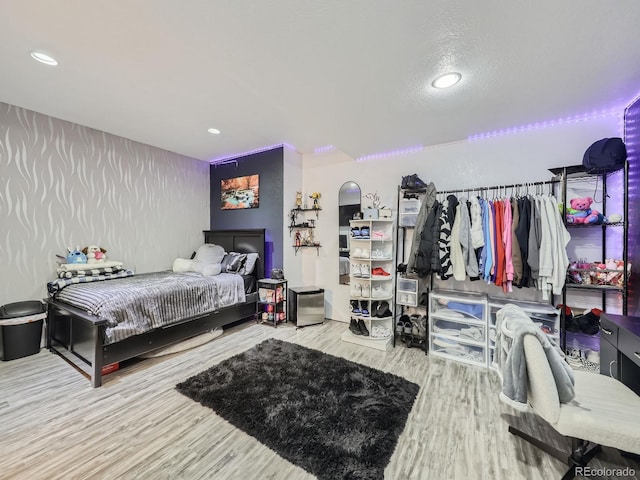 bedroom featuring a textured ceiling and hardwood / wood-style flooring