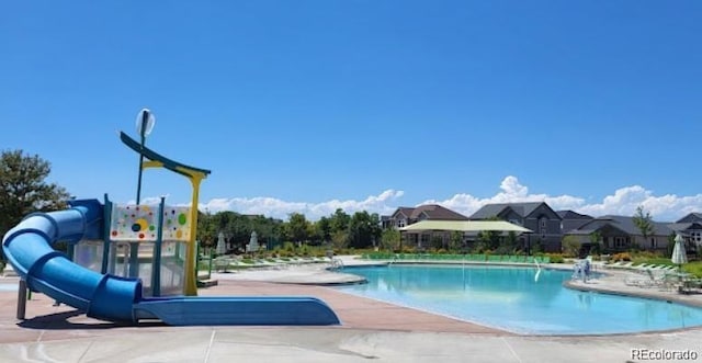 view of pool with a patio and a water slide