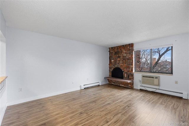 unfurnished living room with a baseboard radiator, a fireplace, a textured ceiling, a baseboard heating unit, and light wood-type flooring