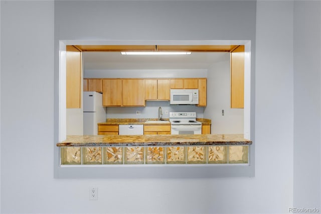 kitchen with white appliances and a sink